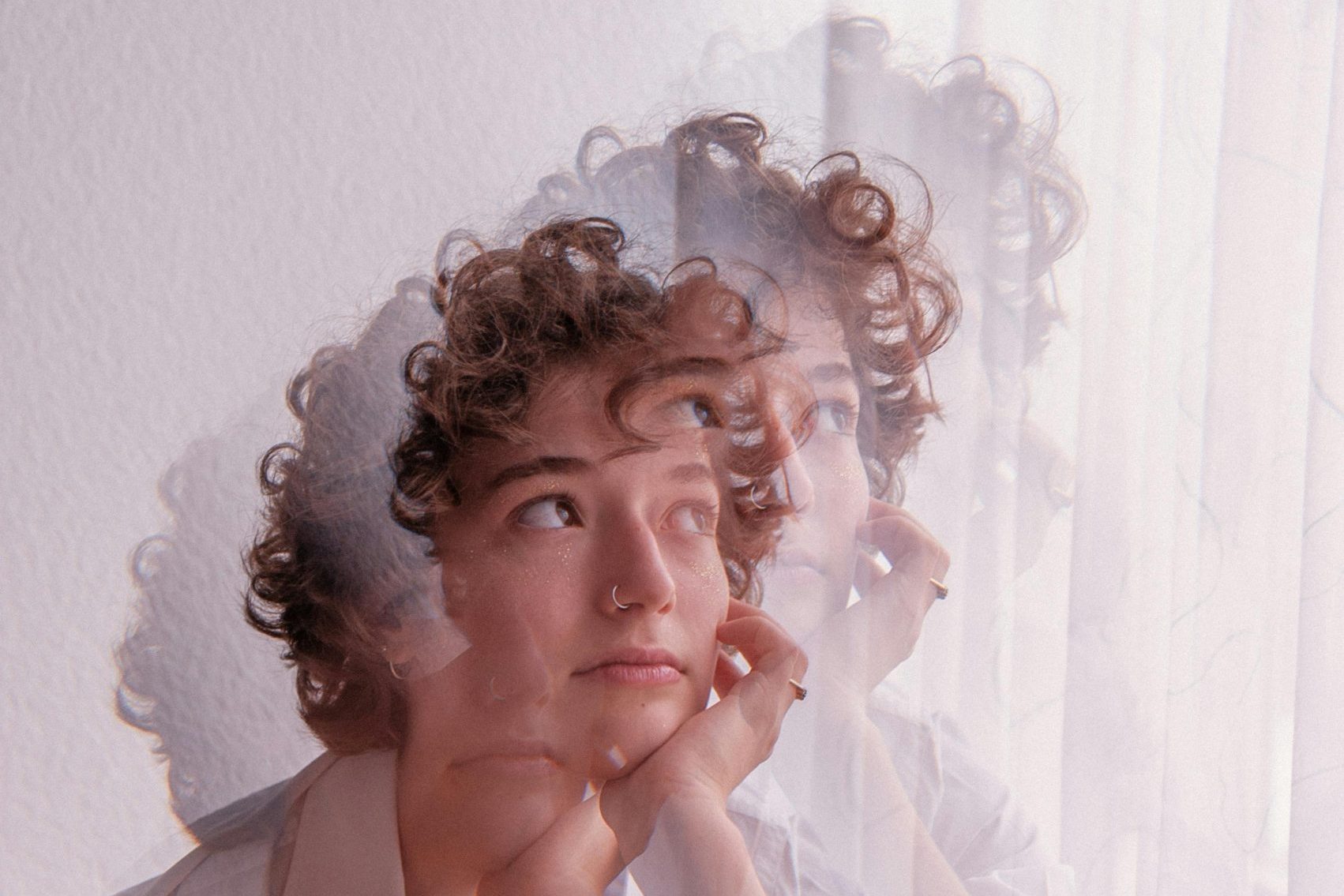 A reflective individual with layered transparency, symbolising the complexity of emotions and personal growth in ADHD coaching.